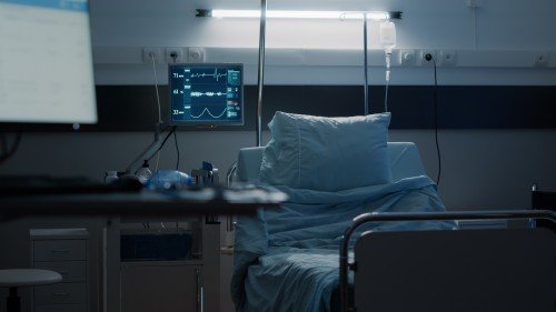 Electric Hospital Bed on Rent in a modern hospital room with a pillow, medical monitor, and IV stand.
